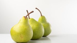 A close-up of ripe green pears in a studio setting, perfect for healthy eating themes.